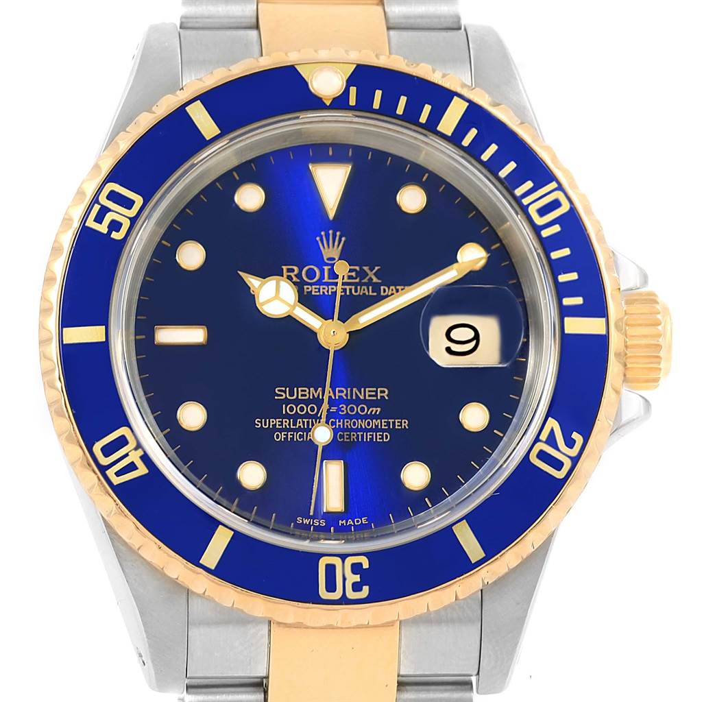 The image shows a Rolex Submariner 16613 Men's Steel and Gold (two tone) Blue Dial 16613 Men's Steel and Gold (two tone) Blue Dial watch in a front view, displaying its blue dial, gold accents, date window, and metal bracelet.