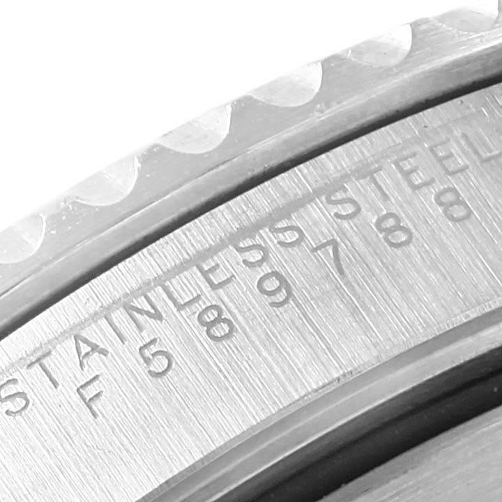 This close-up image shows the engravings and part of the bezel of a Rolex Submariner 14060 Men's Stainless Steel Black Dial 14060 Men's Stainless Steel Black Dial watch.