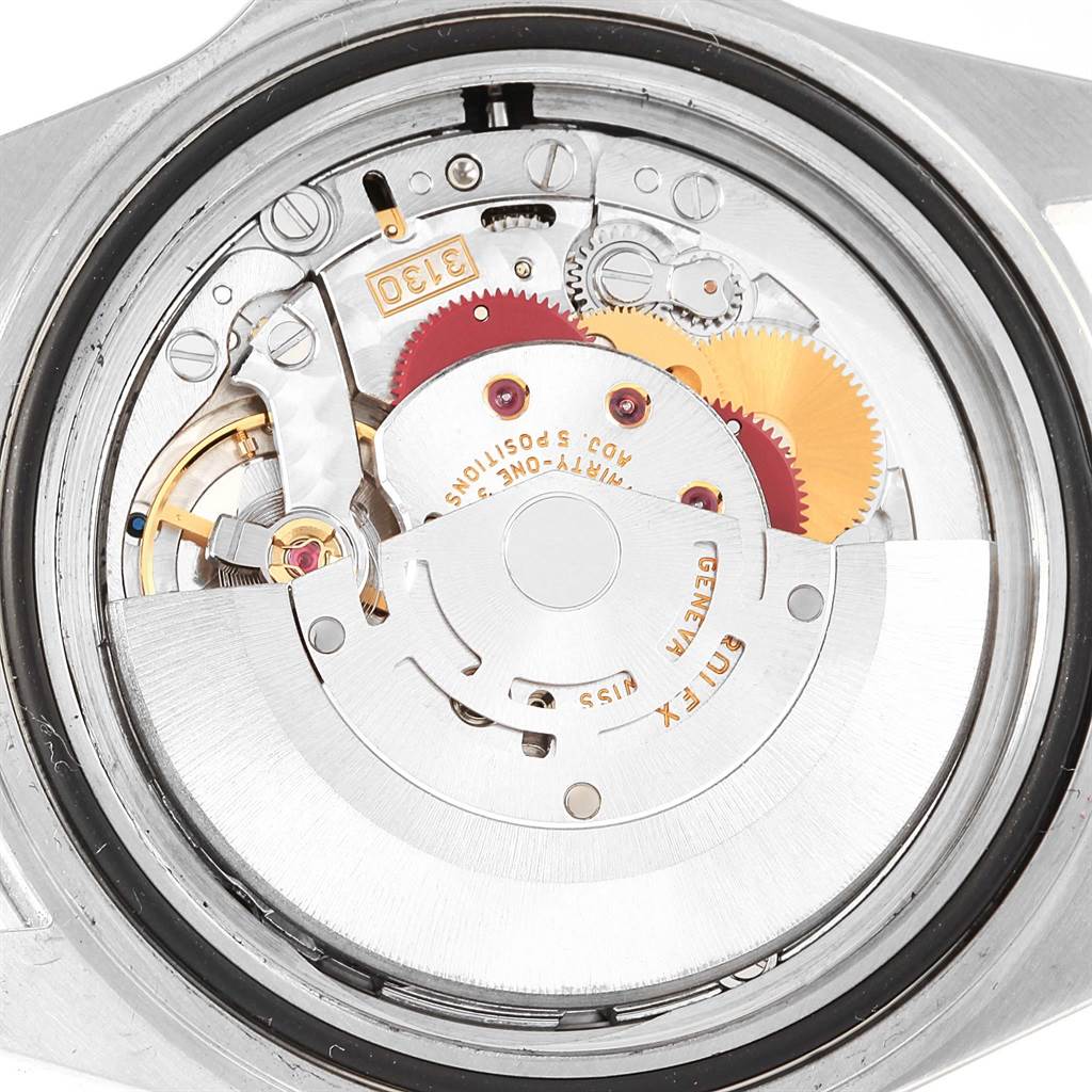 The image shows an inside view of the Rolex Submariner 14060 Men's Stainless Steel Black Dial 14060 Men's Stainless Steel Black Dial watch, highlighting its intricate movement and inner mechanics.