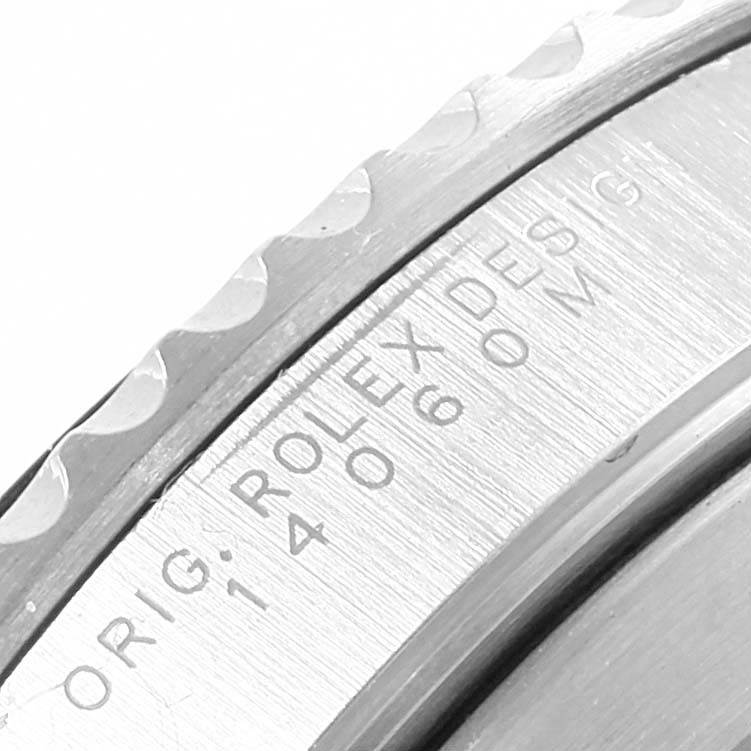This is a close-up of the bezel and inner ring of a Rolex Submariner 14060 Men's Stainless Steel Black Dial 14060 Men's Stainless Steel Black Dial watch, showing the serial and model number engravings.