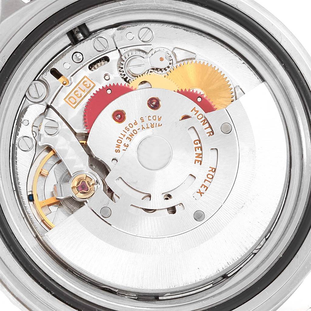 This is a close-up view of the Rolex Submariner 14060 Men's Stainless Steel Black Dial 14060 Men's Stainless Steel Black Dial's movement, showing its intricate gears and mechanical components.