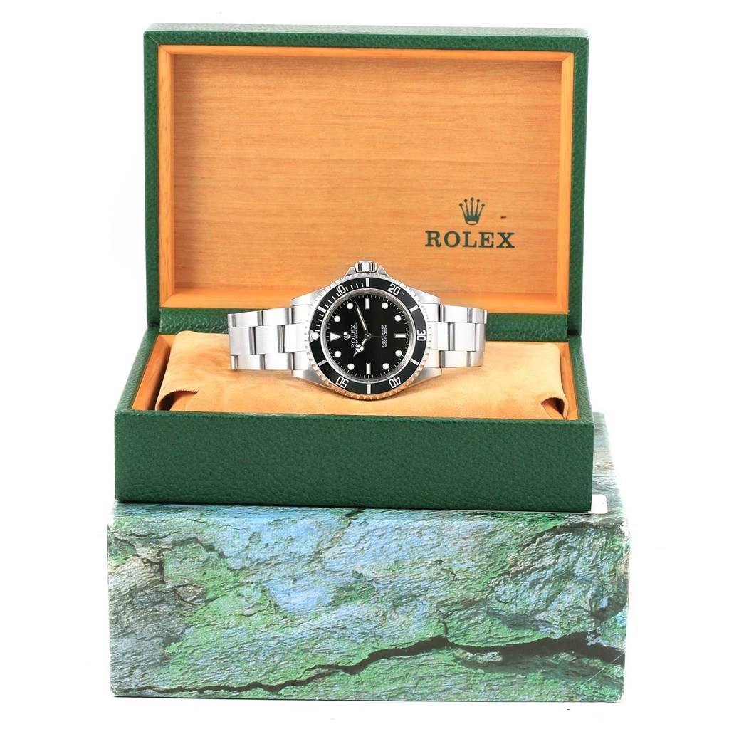 The image shows a Rolex Submariner 14060 Men's Stainless Steel Black Dial 14060 Men's Stainless Steel Black Dial watch displayed inside its open box from a front angle.