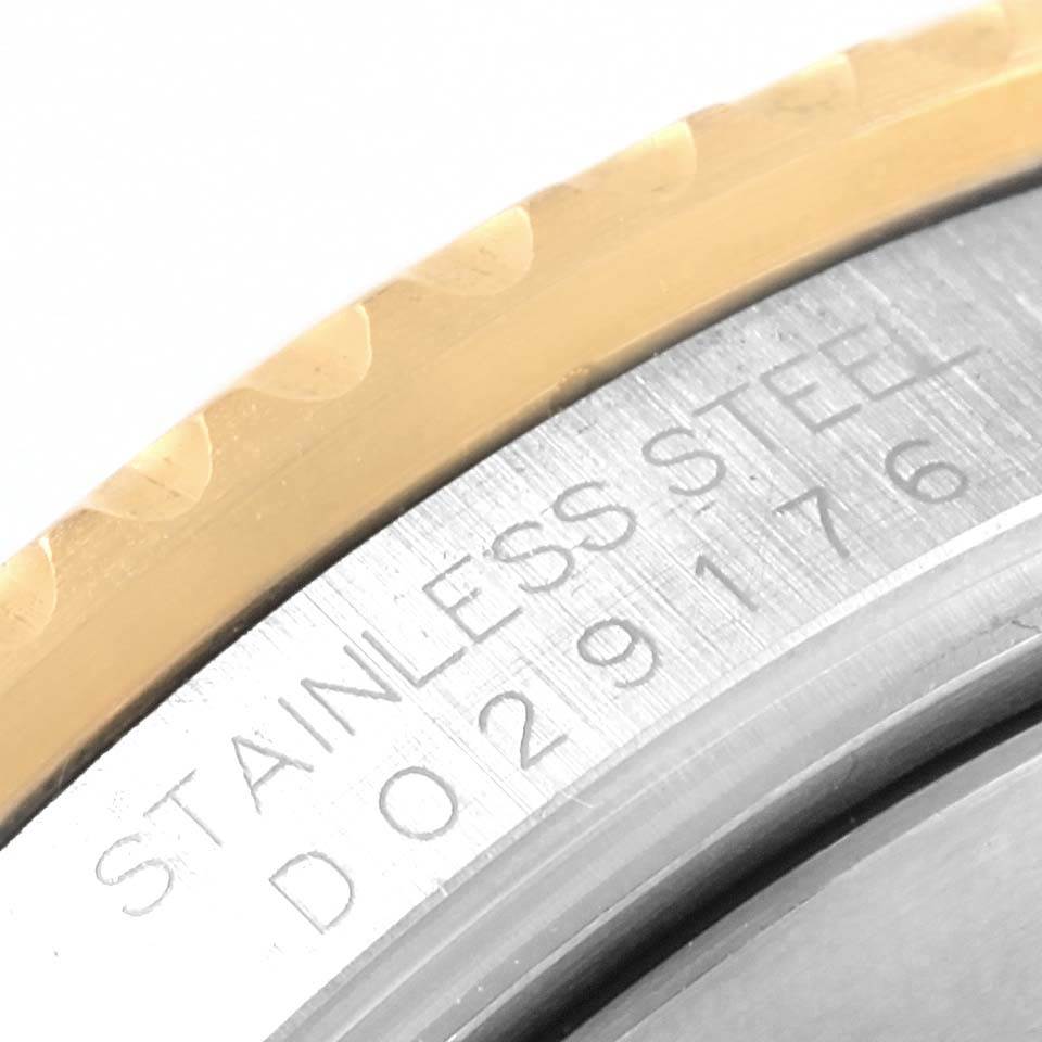 The image shows a close-up of the edge of the bezel and the engravings on the case of a Rolex Submariner 16613 Men's Steel and Gold (two tone) Blue Dial 16613 Men's Steel and Gold (two tone) Blue Dial watch.