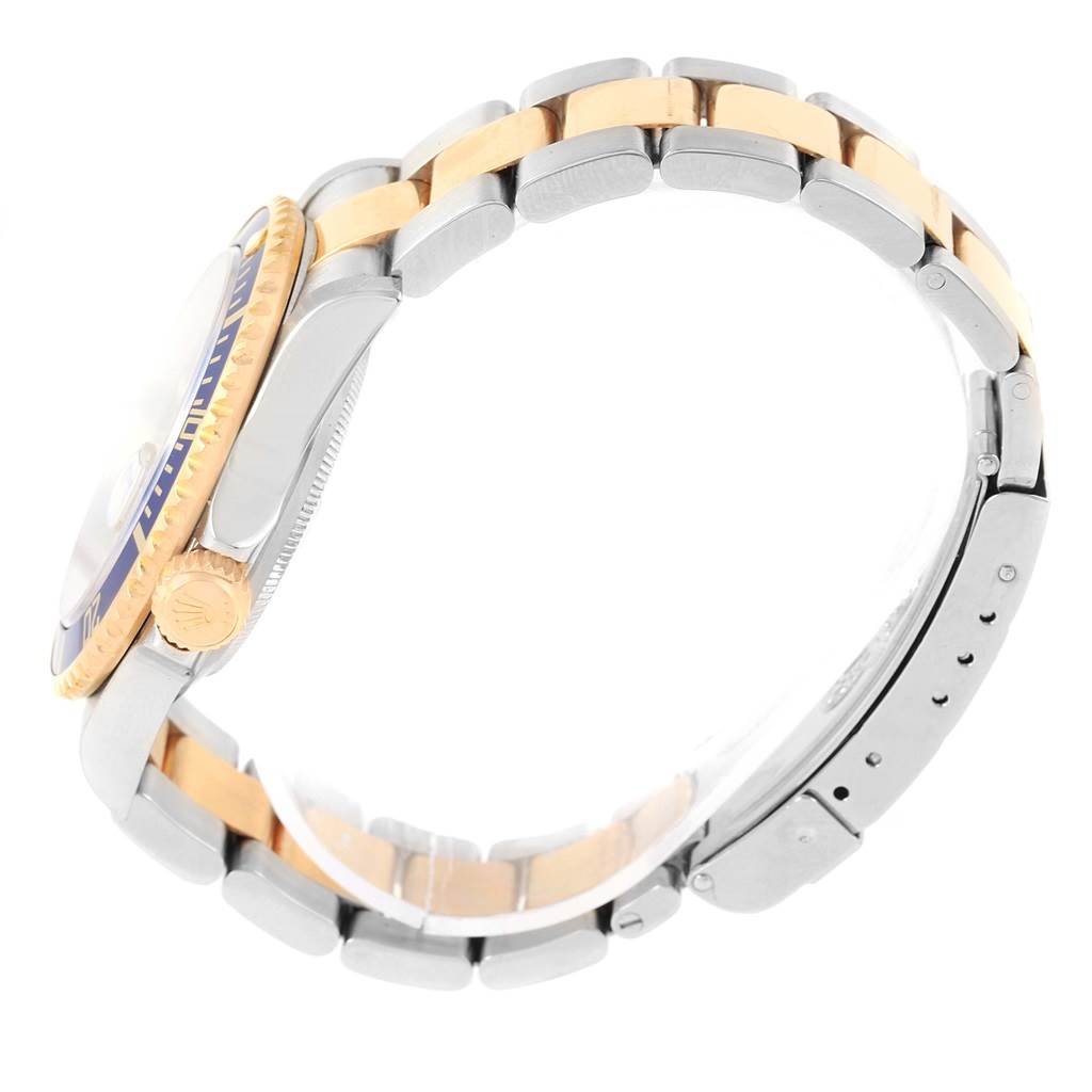 A side view of the Rolex Submariner 16613 Men's Steel and Gold (two tone) Blue Dial 16613 Men's Steel and Gold (two tone) Blue Dial watch showing the case, crown, bezel, and two-tone metal bracelet.