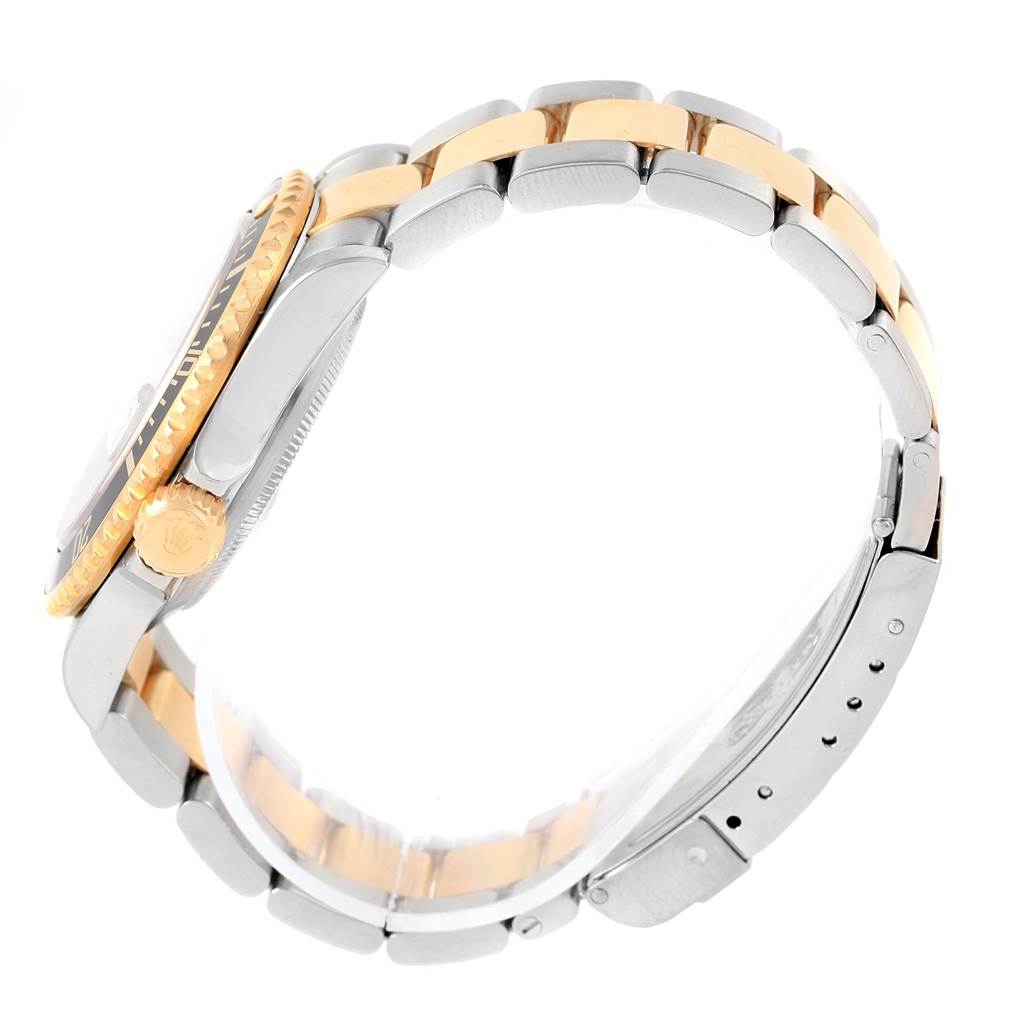 Side angle of a Rolex Submariner 16613 Men's Steel and Gold (two tone) Black Dial 16613 Men's Steel and Gold (two tone) Black Dial showcasing the crown, bezel, and two-tone bracelet.