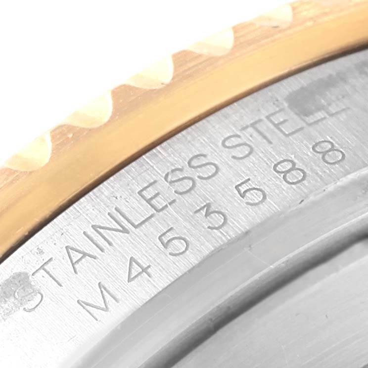 The image shows a close-up view of the case back and bezel of a Rolex Submariner 16613 Men's Steel and Gold (two tone) Black Dial 16613 Men's Steel and Gold (two tone) Black Dial watch, highlighting the stainless steel engraving.