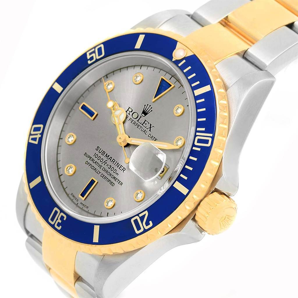 The image shows a close-up of the Rolex Submariner 16613 Men's Steel and Gold (two tone) Grey Dial 16613 Men's Steel and Gold (two tone) Grey Dial watch, featuring its bezel, dial, crown, and part of the bracelet.