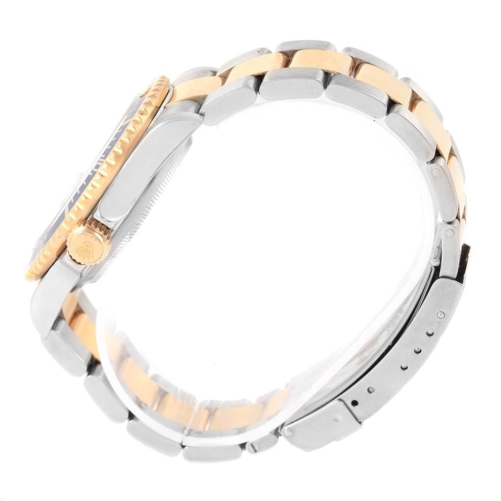 The image shows a side view of a Rolex Submariner 16613 Men's Steel and Gold (two tone) Grey Dial 16613 Men's Steel and Gold (two tone) Grey Dial watch, highlighting its crown, bezel, and two-tone metal bracelet.