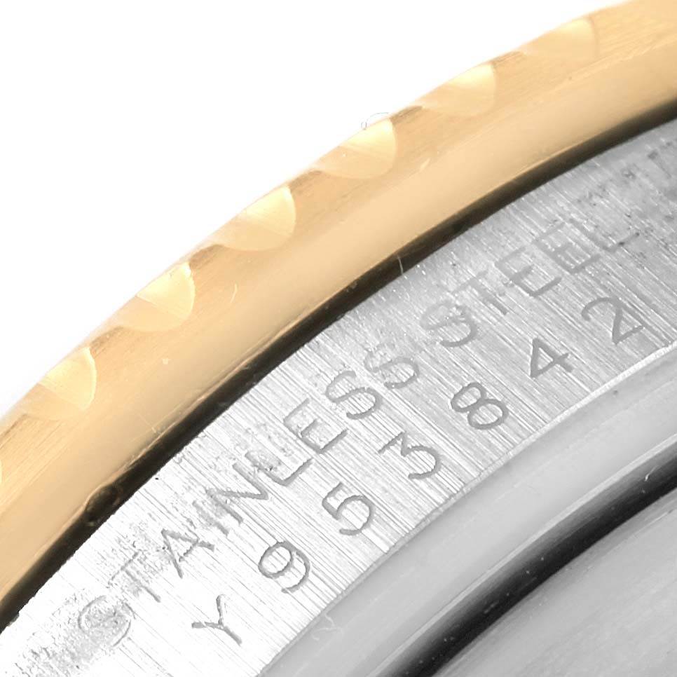 The image shows a close-up angle of the engraved case back and the gold bezel of a Rolex Submariner 16613 Men's Steel and Gold (two tone) Grey Dial 16613 Men's Steel and Gold (two tone) Grey Dial watch.