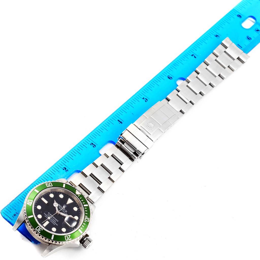 The image shows a top view of the Rolex Submariner 16610LV Men's Stainless Steel Black Dial 16610LV Men's Stainless Steel Black Dial watch, including the dial, bezel, and full bracelet measured against a ruler.