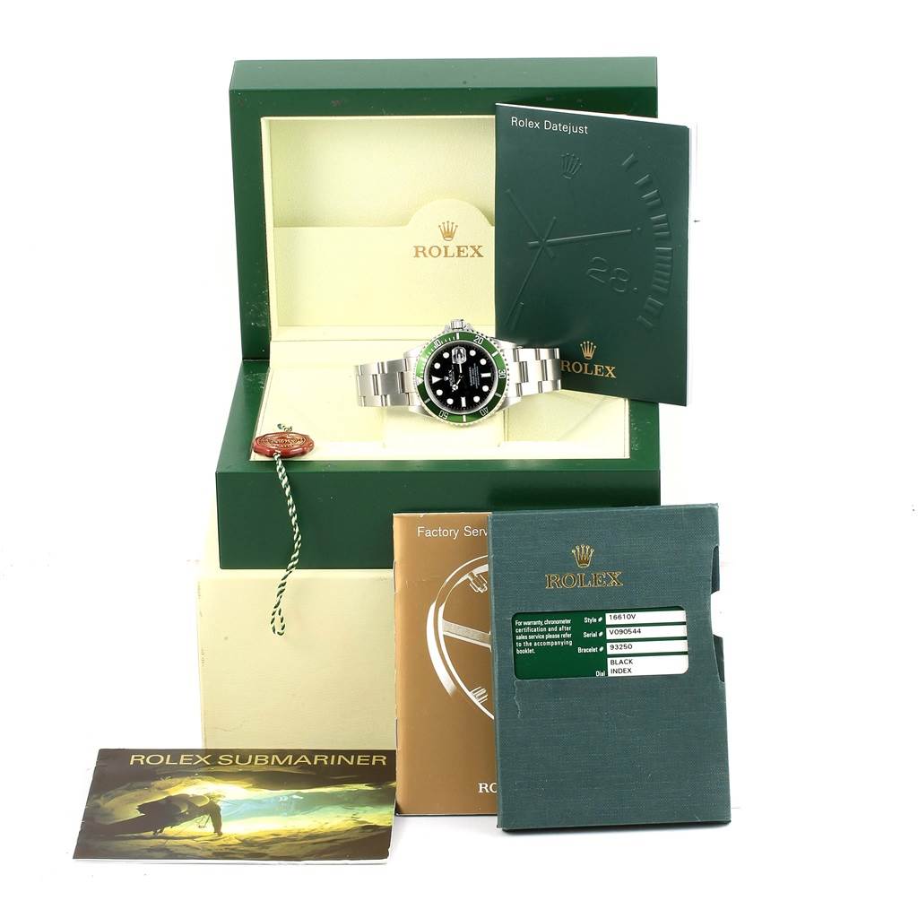 The image shows a Rolex Submariner 16610LV Men's Stainless Steel Black Dial 16610LV Men's Stainless Steel Black Dial watch, its open box, manuals, and service booklets.