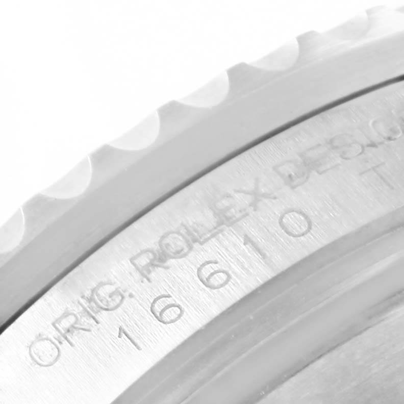 The image shows a close-up of the engraved bezel edge of a Rolex Submariner 16610LV Men's Stainless Steel Black Dial 16610LV Men's Stainless Steel Black Dial, model 16610.