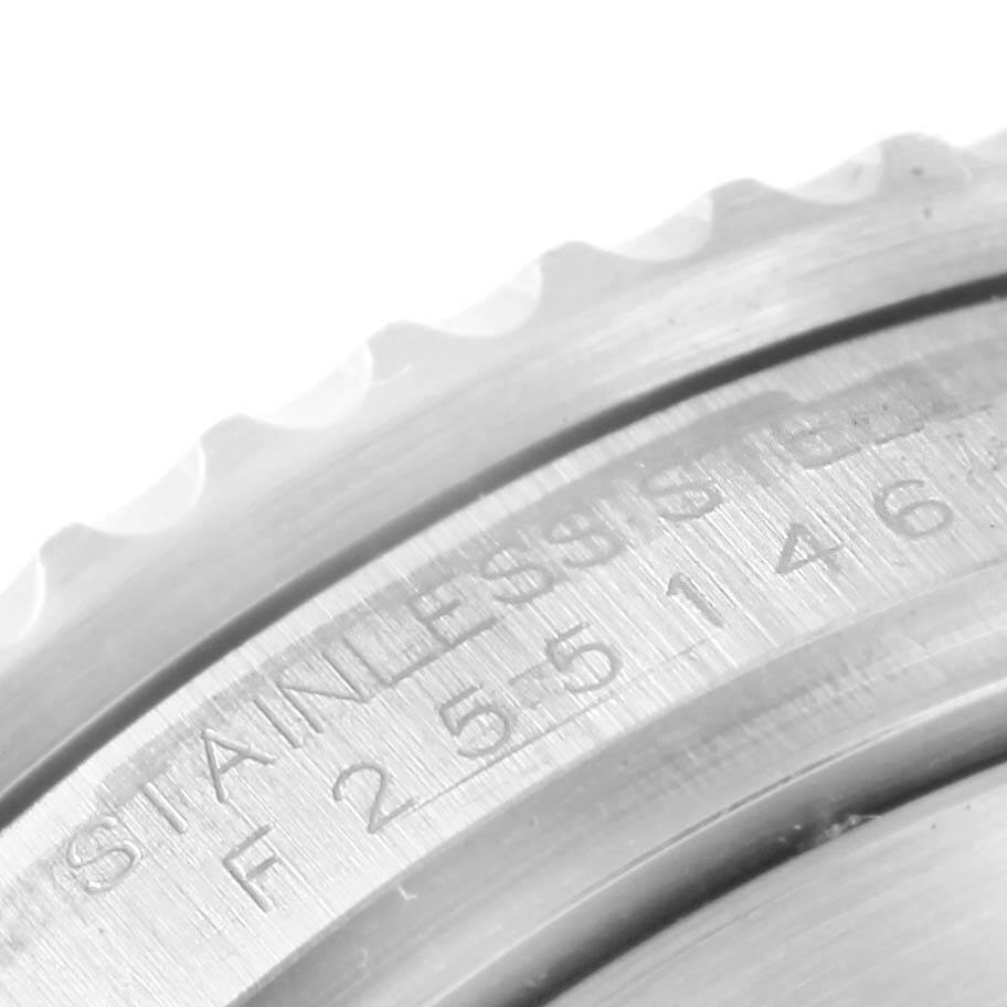 The image shows a close-up of the bezel and part of the engraved stainless steel casing of a Rolex Submariner 16610 Men's Stainless Steel Black Dial 16610 Men's Stainless Steel Black Dial watch.