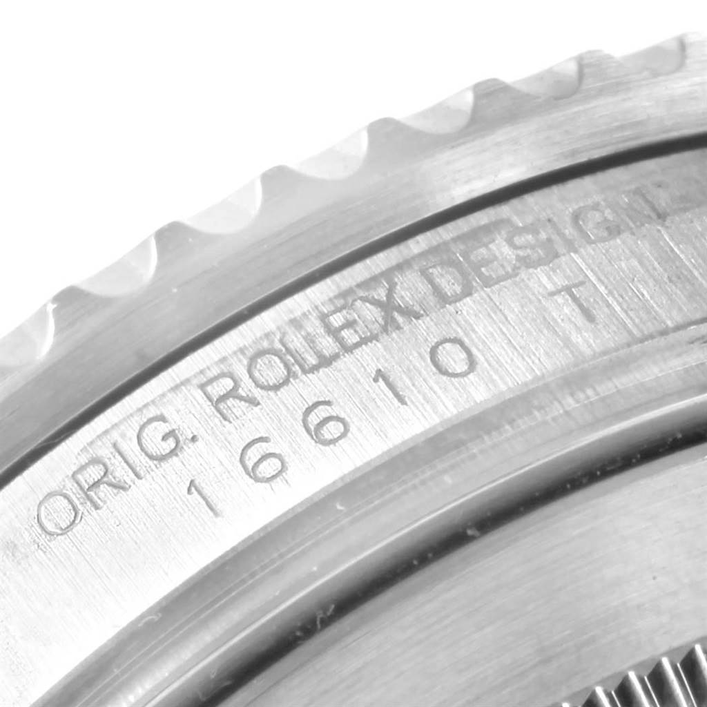 The image shows a close-up of the bezel and edge of the case of a Rolex Submariner 16610 Men's Stainless Steel Black Dial 16610 Men's Stainless Steel Black Dial, highlighting the engraved "ORIG. ROLEX DESIGN" and model number.