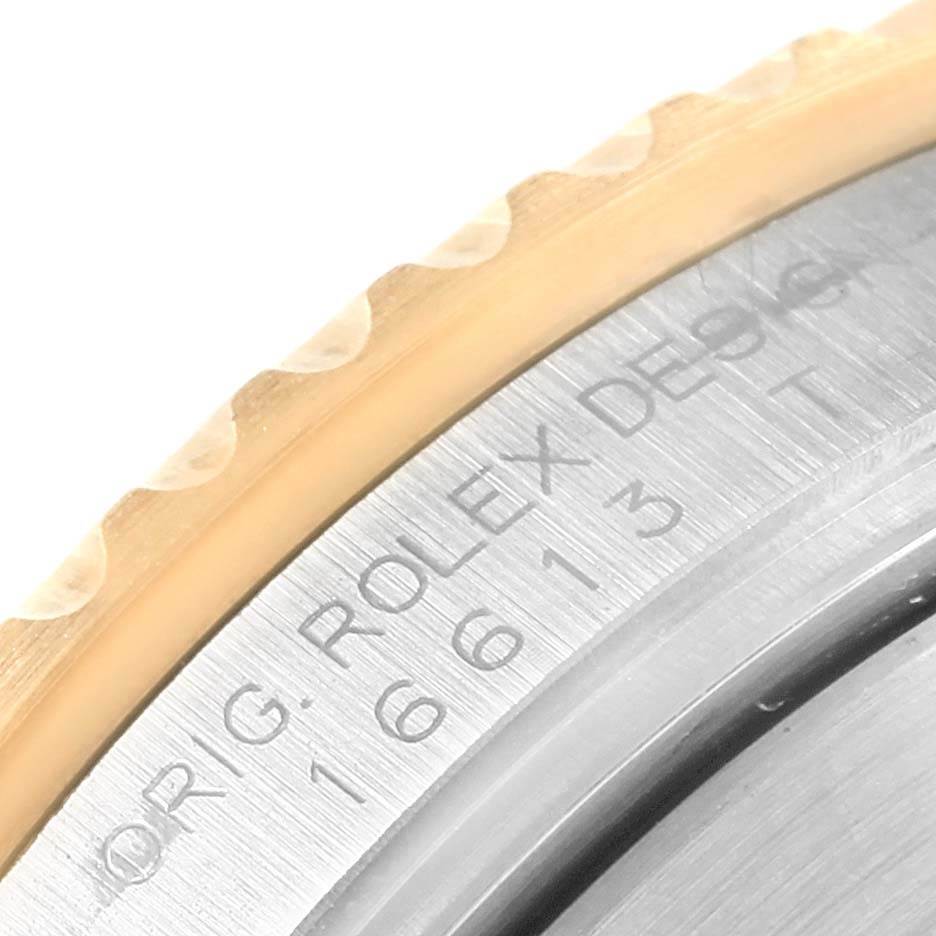 The image shows a close-up of the bezel and case side of a Rolex Submariner 16613 Men's Steel and Gold (two tone) Black Dial 16613 Men's Steel and Gold (two tone) Black Dial watch, highlighting its engraved details.