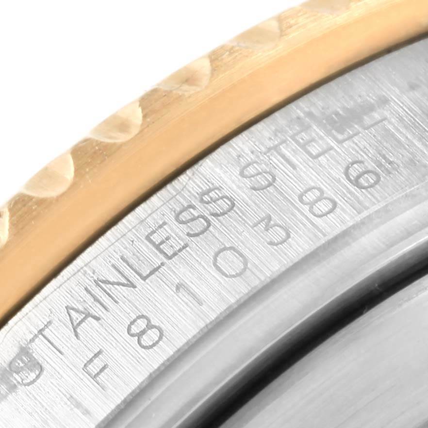 The image shows a close-up of the stainless steel and gold bezel of a Rolex Submariner 16613 Men's Steel and Gold (two tone) Black Dial 16613 Men's Steel and Gold (two tone) Black Dial, highlighting its engraving.