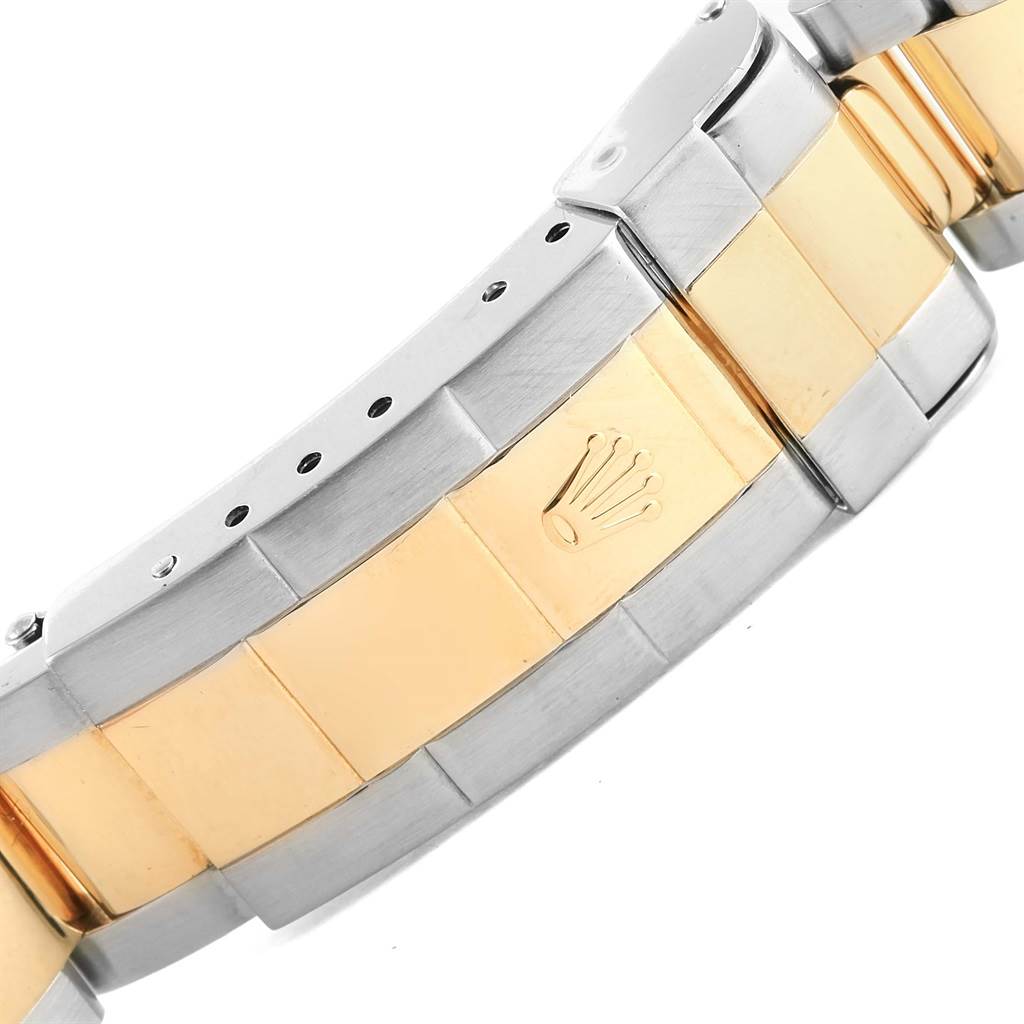 This image shows a close-up of the bicolor stainless steel and gold bracelet of a Rolex Submariner 16613 Men's Steel and Gold (two tone) Black Dial 16613 Men's Steel and Gold (two tone) Black Dial watch.