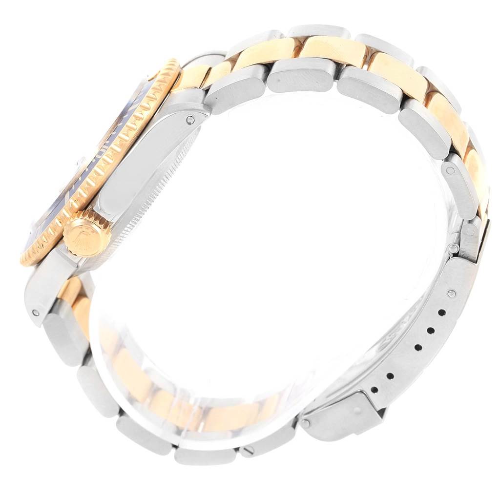 The image shows a side view of a Rolex Submariner 16613 Men's Steel and Gold (two tone) Blue Dial 16613 Men's Steel and Gold (two tone) Blue Dial watch, highlighting its two-tone bracelet and crown.