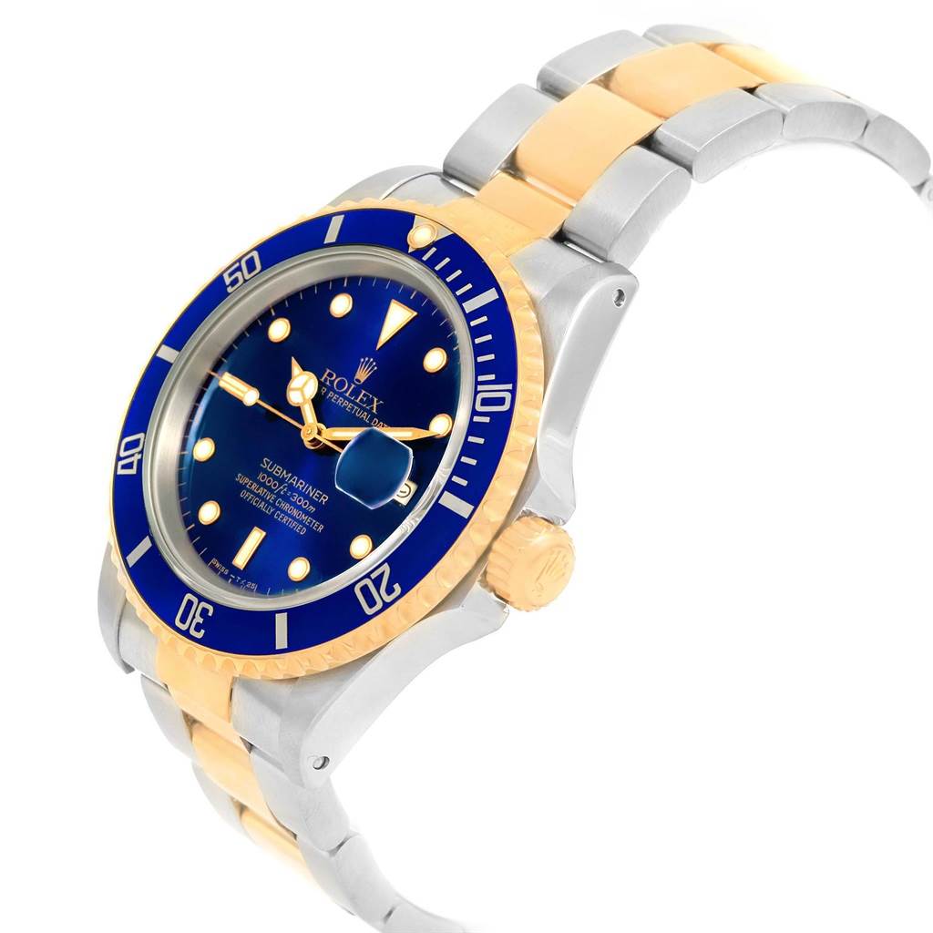 The image shows a Rolex Submariner 16613 Men's Steel and Gold (two tone) Blue Dial 16613 Men's Steel and Gold (two tone) Blue Dial watch at an angled view highlighting its blue dial, bezel, and two-tone bracelet.