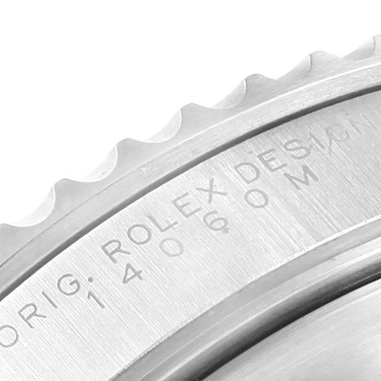 This close-up image shows the ridged bezel and engraved case back of a Rolex Submariner 14060 Men's Stainless Steel Black Dial 14060 Men's Stainless Steel Black Dial watch.