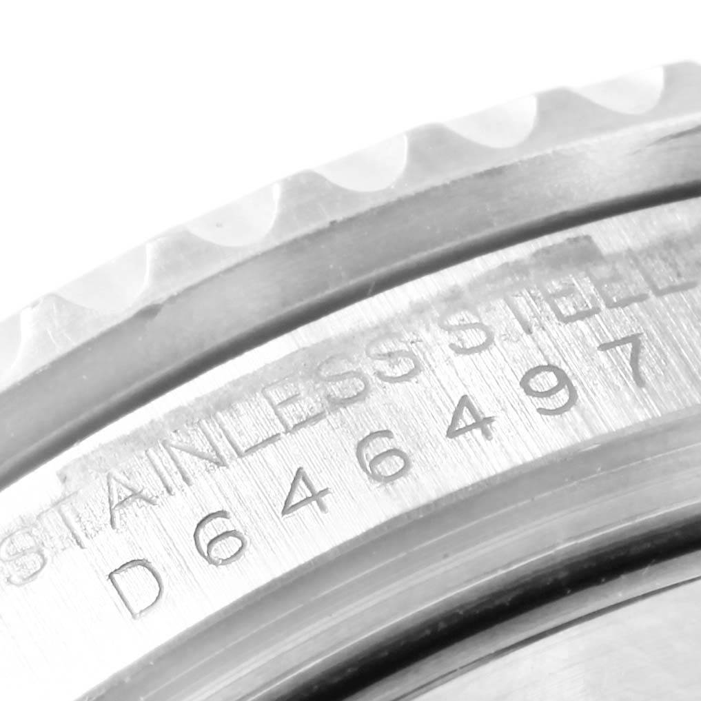 This image shows a close-up of the bezel and serial number engraving on a Rolex Submariner 16610LV Men's Stainless Steel Black Dial 16610LV Men's Stainless Steel Black Dial watch.