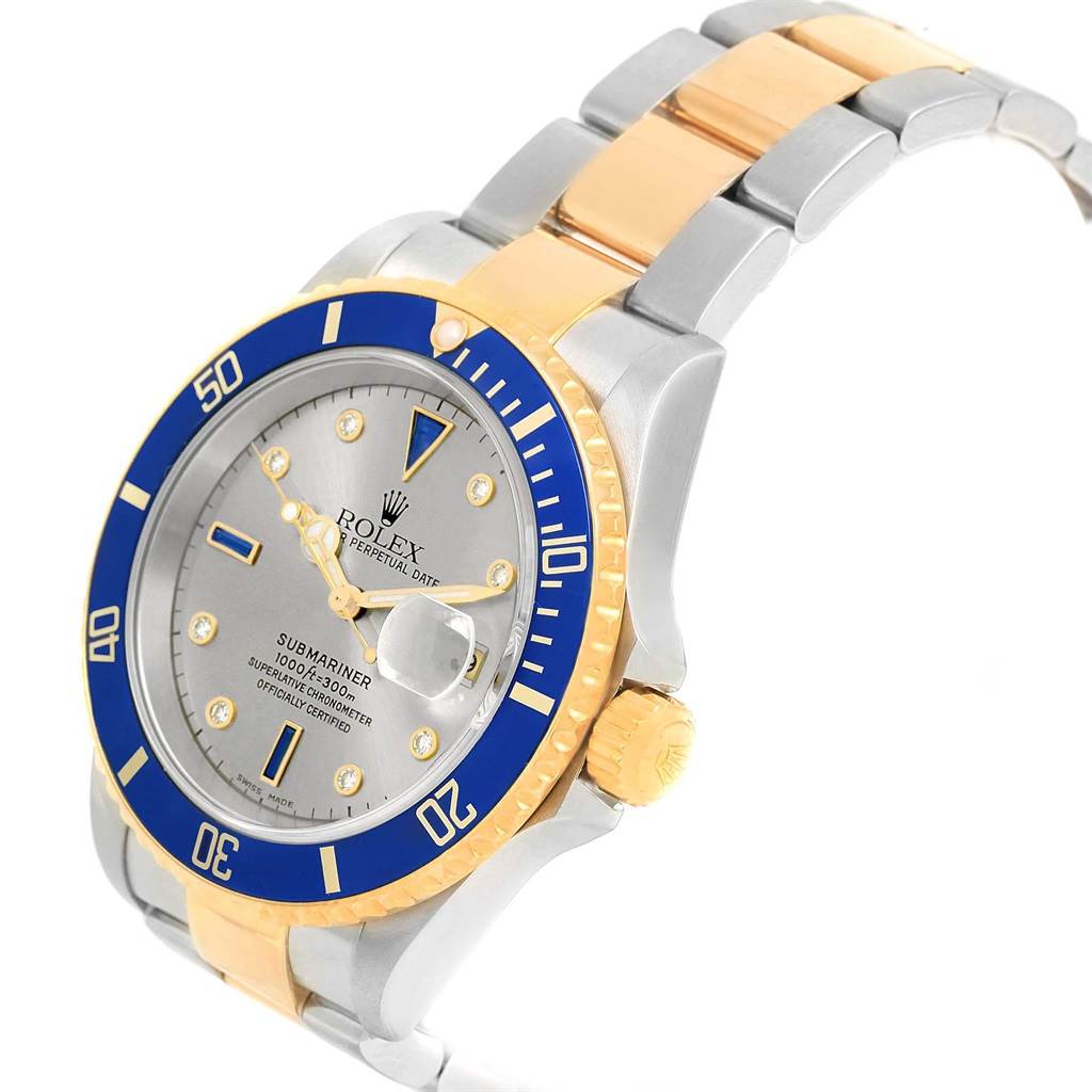 This image shows a Rolex Submariner 16613 Men's Steel and Gold (two tone) Grey Dial 16613 Men's Steel and Gold (two tone) Grey Dial watch from an oblique angle, highlighting the bezel, dial, crown, and bracelet.