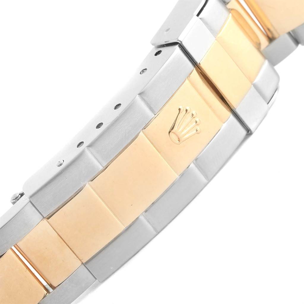 The image shows a side angle of the bracelet of a Rolex Submariner 16613 Men's Steel and Gold (two tone) Grey Dial 16613 Men's Steel and Gold (two tone) Grey Dial watch, highlighting its two-tone metal and clasp with the Rolex logo.