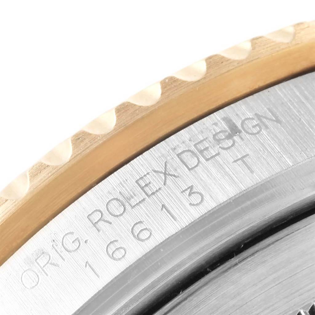 The image shows a close-up of the bezel and case side of the Rolex Submariner 16613 Men's Steel and Gold (two tone) Blue Dial 16613 Men's Steel and Gold (two tone) Blue Dial watch, revealing part of the engraved model number.