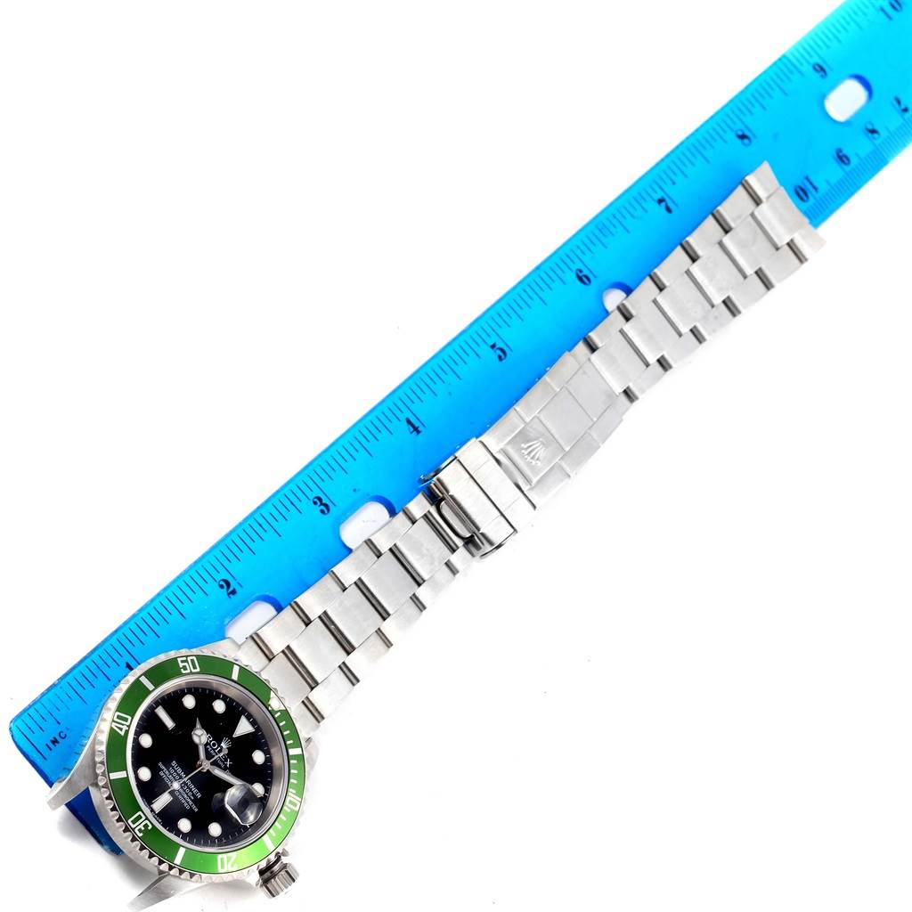 The image shows a Rolex Submariner 16610LV Men's Stainless Steel Black Dial 16610LV Men's Stainless Steel Black Dial watch laid flat with a blue ruler measuring its length.