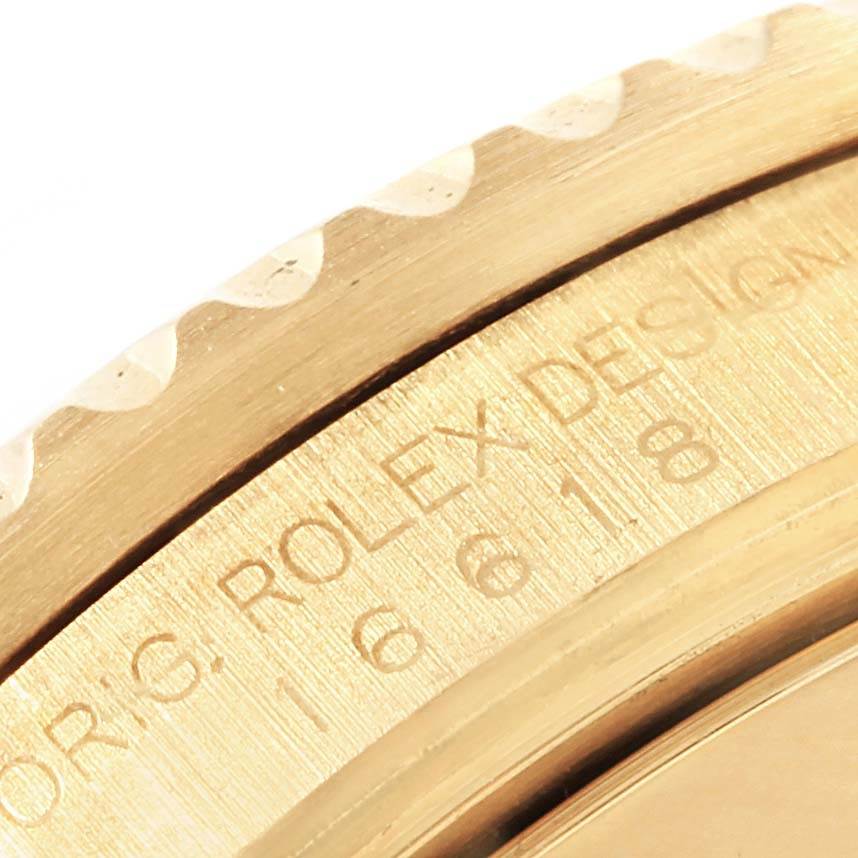 The image shows a close-up of the bezel and engraved case of a Rolex Submariner 16618 Men
s Yellow Gold Black Dial 16618 Men
s Yellow Gold Black Dial watch.