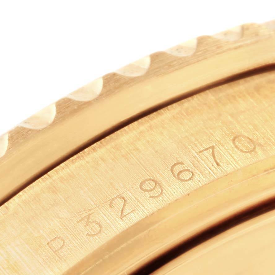 The image shows a close-up of the bezel and serial number engravings of a Rolex Submariner 16618 Men
s Yellow Gold Black Dial 16618 Men
s Yellow Gold Black Dial watch.