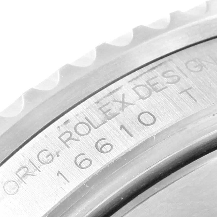 This close-up image shows the engraved details on the bezel and case of a Rolex Submariner 16610 Men's Stainless Steel Black Dial 16610 Men's Stainless Steel Black Dial watch.