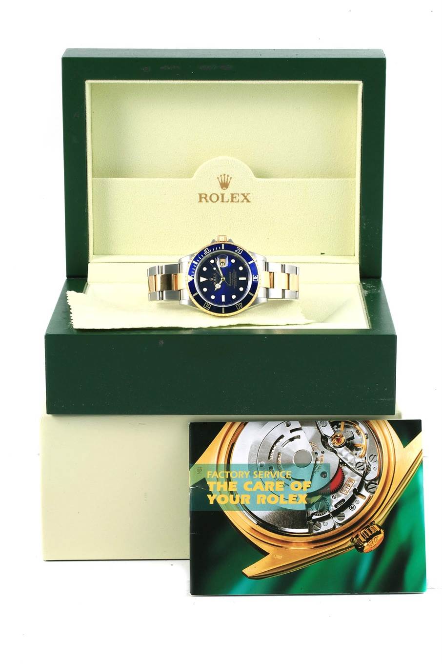 The Rolex Submariner 16613 Men's Steel and Gold (two tone) Blue Dial 16613 Men's Steel and Gold (two tone) Blue Dial watch is displayed front-on in its open box with a care manual in front.