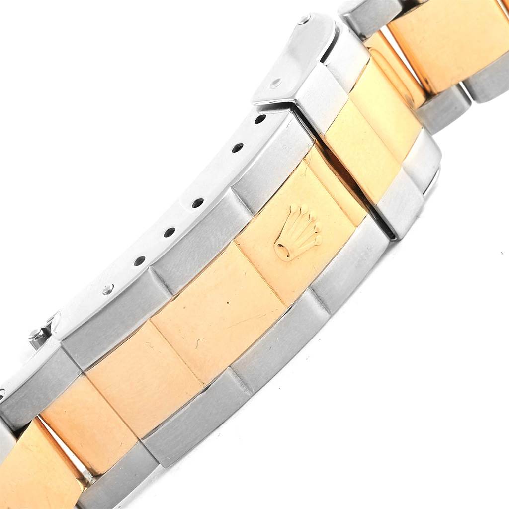 The image shows a close-up view of the bracelet of a Rolex Submariner 16613 Men's Steel and Gold (two tone) Blue Dial 16613 Men's Steel and Gold (two tone) Blue Dial watch, featuring gold and stainless steel links with the Rolex crown logo.