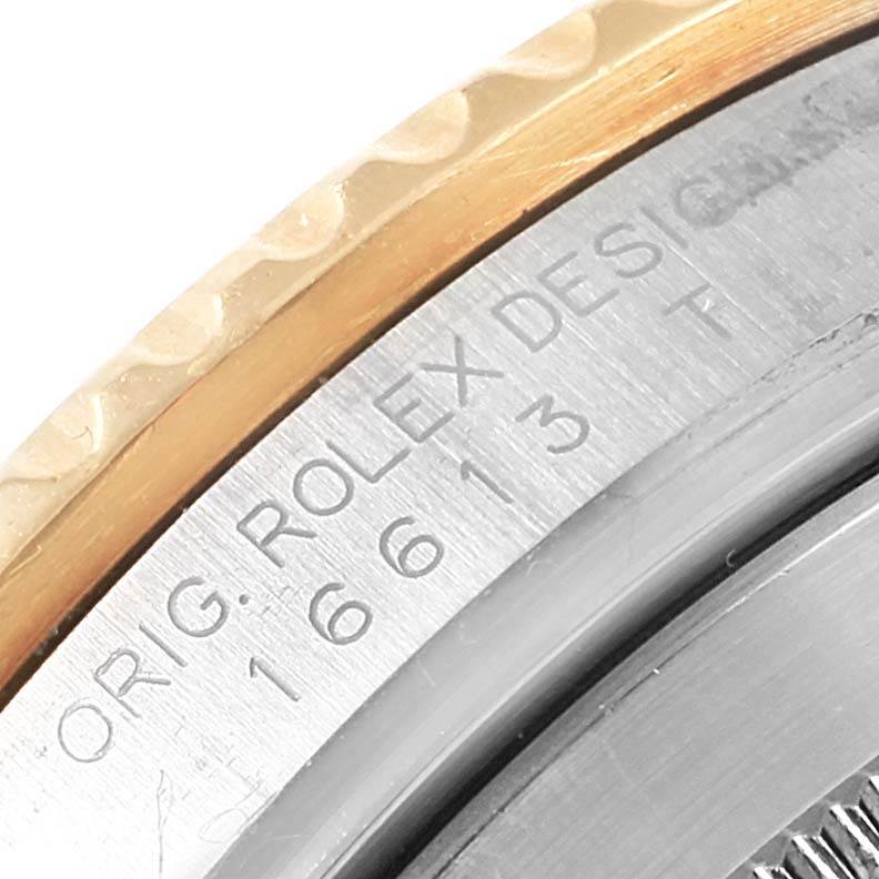 The image shows a close-up of the side and part of the bezel of a Rolex Submariner 16613 Men's Steel and Gold (two tone) Blue Dial 16613 Men's Steel and Gold (two tone) Blue Dial watch, highlighting the engraved model number and "ROLEX DESIGN" text.