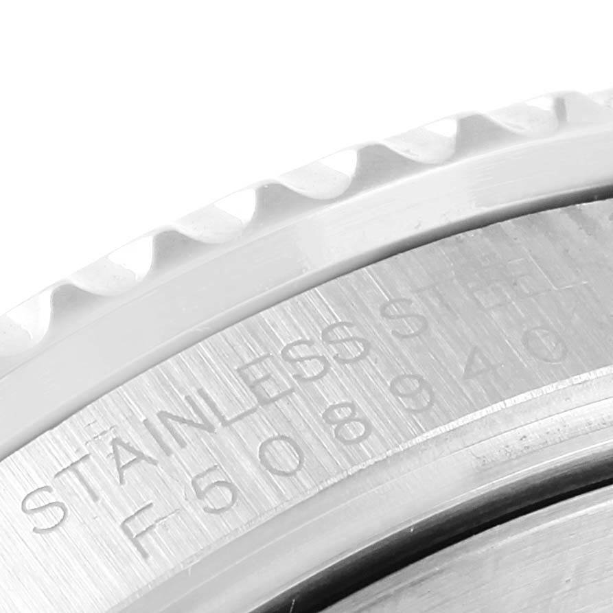 This close-up image shows the engraved stainless steel case and serrated bezel of a Rolex Submariner 16610LV Men's Stainless Steel Black Dial 16610LV Men's Stainless Steel Black Dial watch.