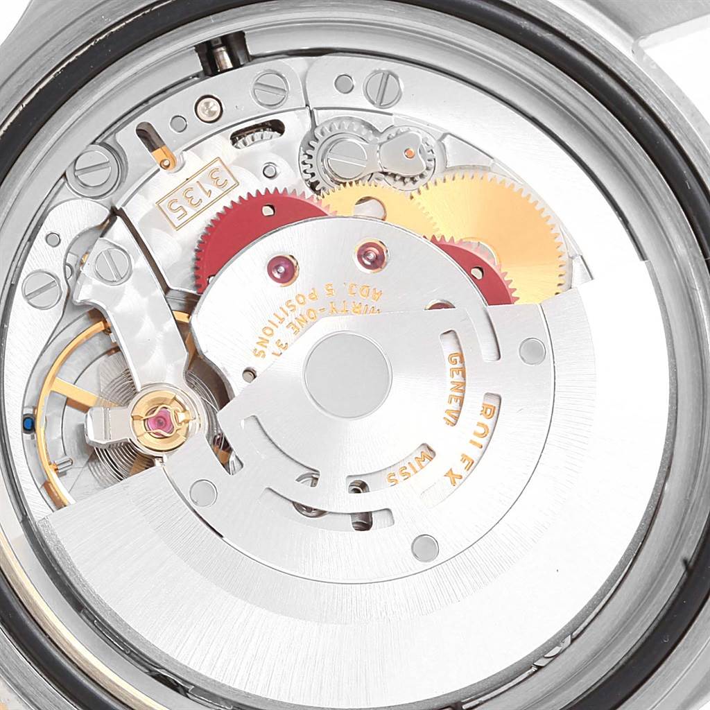 Close-up view of the Rolex Submariner 16613 Men's Steel and Gold (two tone) Blue Dial 16613 Men's Steel and Gold (two tone) Blue Dial's movement, showcasing gears, rotors, and intricate mechanical parts.