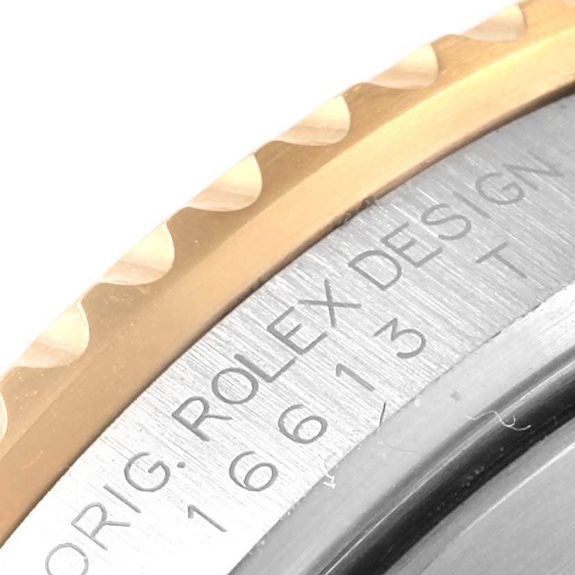 This image shows a close-up of the bezel and case side inscription of a Rolex Submariner 16613 Men's Steel and Gold (two tone) Blue Dial 16613 Men's Steel and Gold (two tone) Blue Dial.