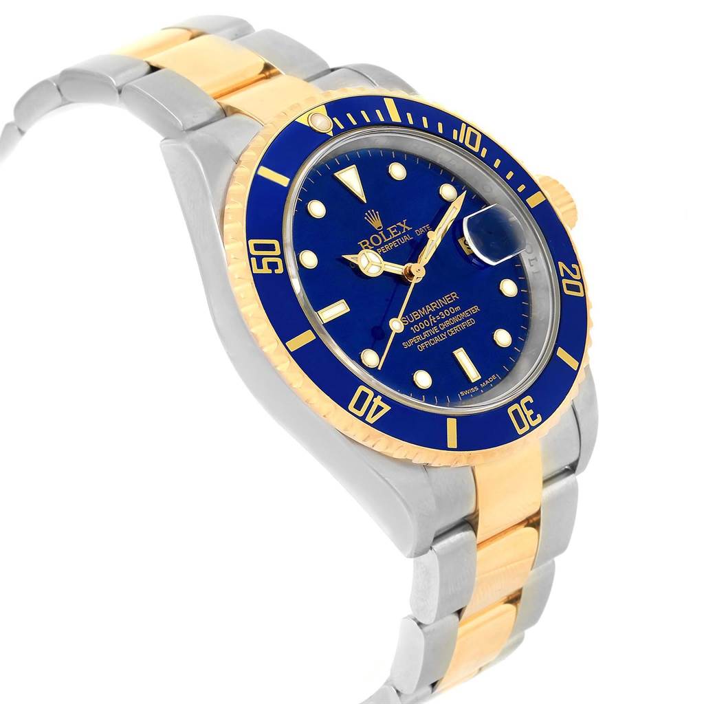The image shows the Rolex Submariner 16613 Men's Steel and Gold (two tone) Blue Dial 16613 Men's Steel and Gold (two tone) Blue Dial watch from a three-quarter angled view, highlighting its blue dial, bezel, and two-tone bracelet.