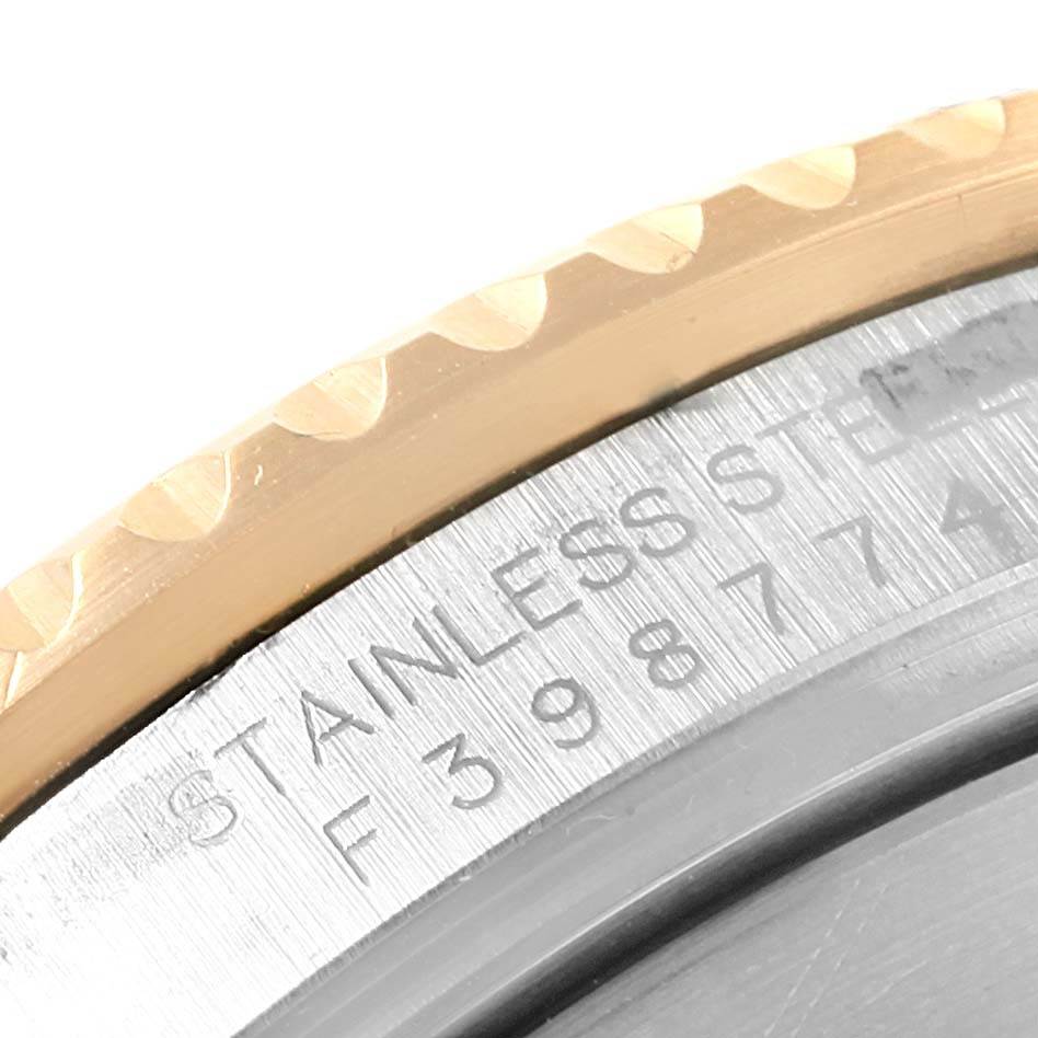 This image shows a close-up of the serial number and part of the bezel on a Rolex Submariner 16613 Men's Steel and Gold (two tone) Blue Dial 16613 Men's Steel and Gold (two tone) Blue Dial watch.