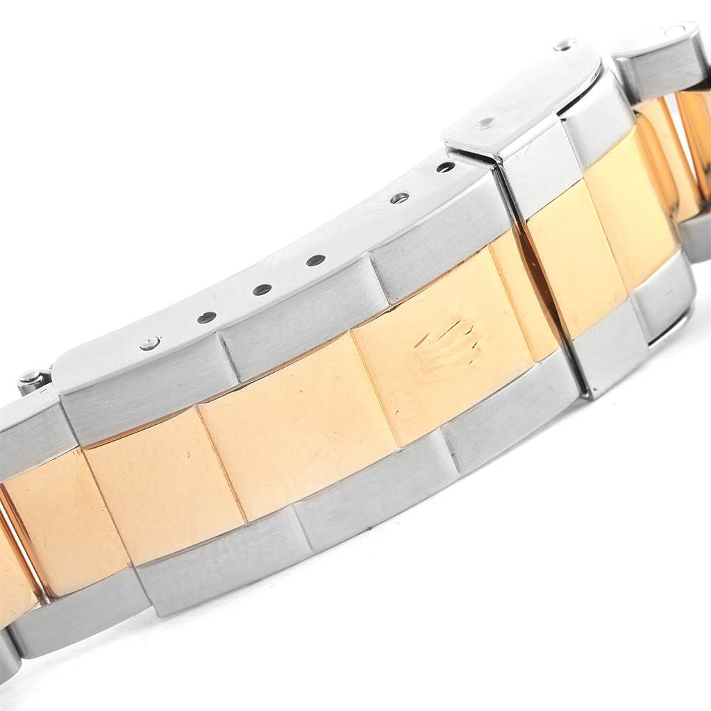 The image shows a close-up view of the bracelet clasp of a Rolex Submariner 16613 Men's Steel and Gold (two tone) Blue Dial 16613 Men's Steel and Gold (two tone) Blue Dial watch, highlighting the two-tone metal design.