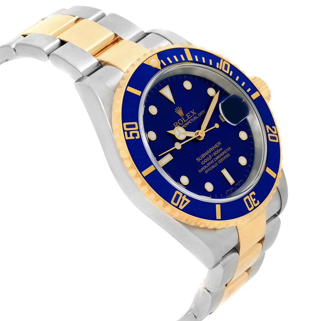 The image shows a Rolex Submariner 16613 Men's Steel and Gold (two tone) Blue Dial 16613 Men's Steel and Gold (two tone) Blue Dial watch from an oblique angle, highlighting its blue dial, bezel, and two-tone bracelet.