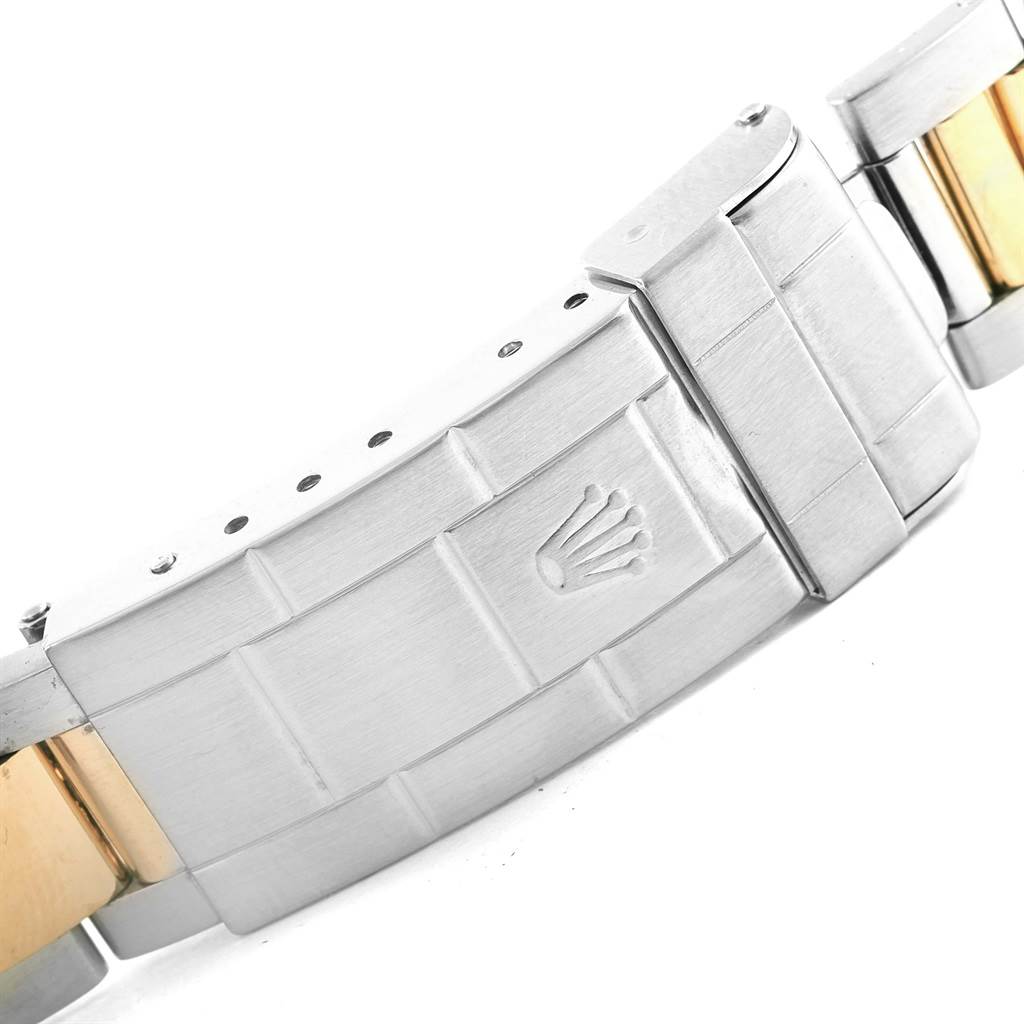 The image shows a close-up of the clasp and part of the bracelet of a Rolex Submariner 16613 Men's Steel and Gold (two tone) Champagne Dial 16613 Men's Steel and Gold (two tone) Champagne Dial watch.