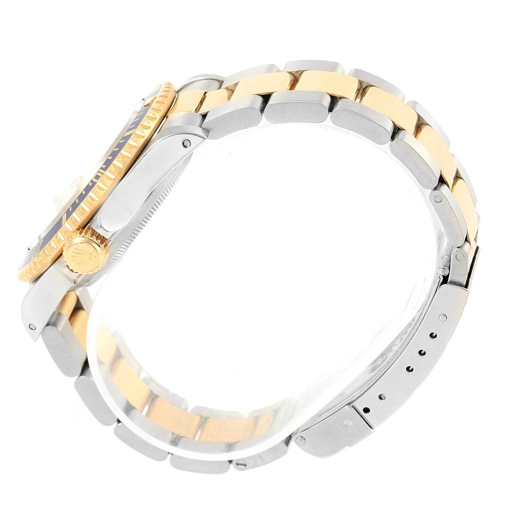 This image shows a side view of a Rolex Submariner 16613 Men's Steel and Gold (two tone) Champagne Dial 16613 Men's Steel and Gold (two tone) Champagne Dial watch, highlighting its two-tone bracelet, crown, and part of the bezel.