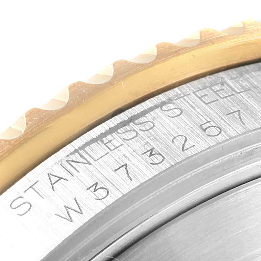 This close-up shows the bezel and a portion of the engraved serial number on a Rolex Submariner 16613 Men's Steel and Gold (two tone) Champagne Dial 16613 Men's Steel and Gold (two tone) Champagne Dial watch.