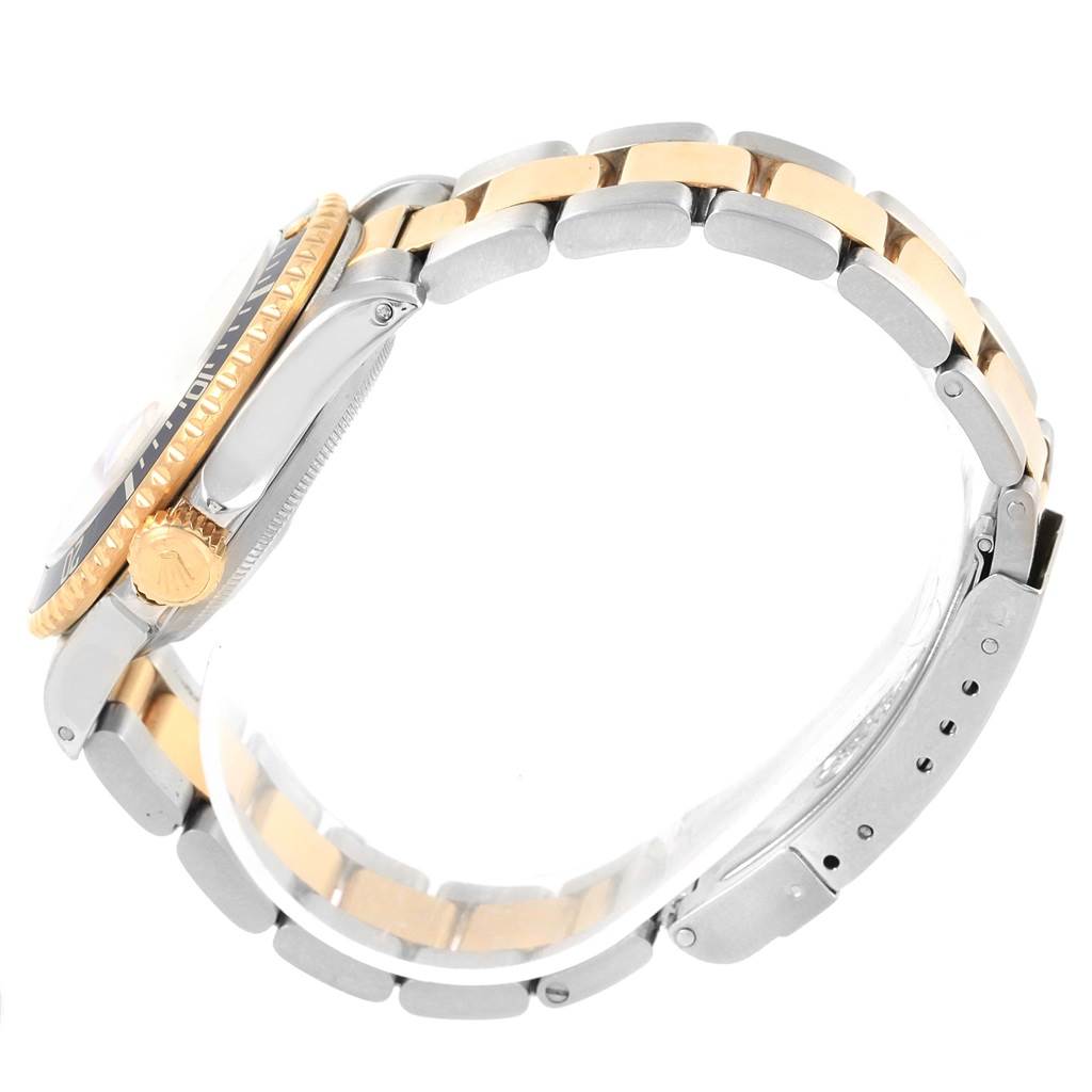 This side view image of the Rolex Submariner 16613 Men's Steel and Gold (two tone) Champagne Dial 16613 Men's Steel and Gold (two tone) Champagne Dial shows the watch case, crown, and two-tone bracelet.