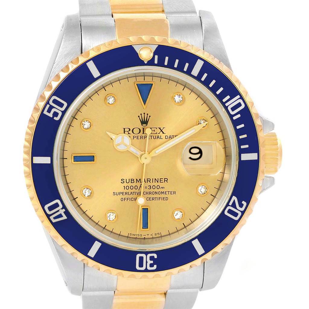 The image shows a frontal view of a Rolex Submariner 16613 Men's Steel and Gold (two tone) Champagne Dial 16613 Men's Steel and Gold (two tone) Champagne Dial watch, highlighting its gold dial, blue bezel, and date window at the 3 o'clock position.
