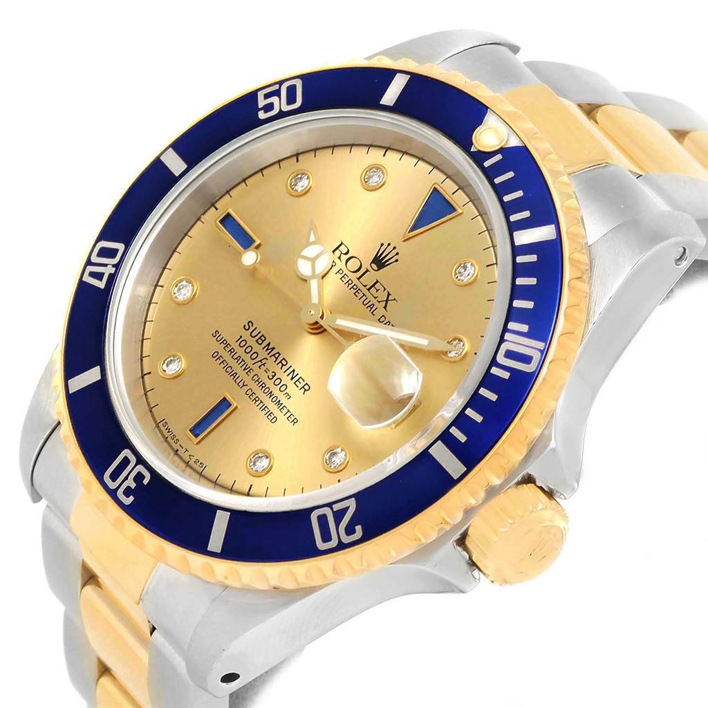 The image shows a Rolex Submariner 16613 Men's Steel and Gold (two tone) Champagne Dial 16613 Men's Steel and Gold (two tone) Champagne Dial watch at a tilted angle, highlighting its dial, bezel, crown, and part of the bracelet.
