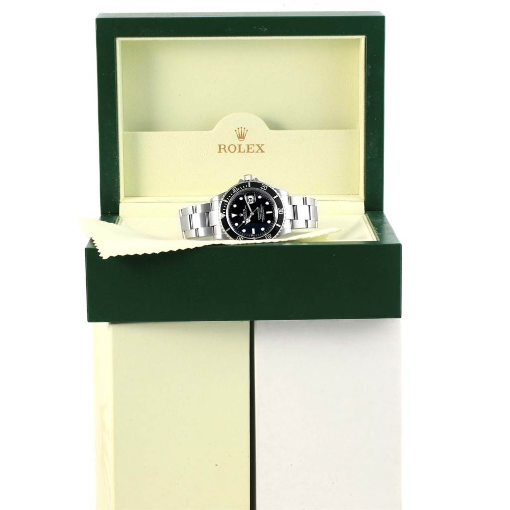The image shows a Rolex Submariner 16610 Men's Stainless Steel Black Dial 16610 Men's Stainless Steel Black Dial watch displayed inside its green and cream-colored box, viewed from the front.