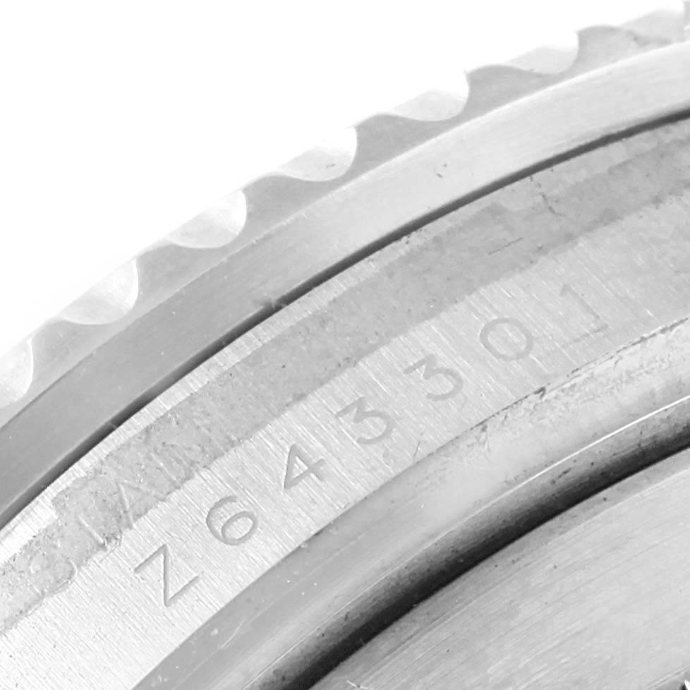 The image shows the serial number engraved on the side of the case and the bezel edge of a Rolex Submariner 16610 Men's Stainless Steel Black Dial 16610 Men's Stainless Steel Black Dial watch.